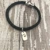 Leather bracelet with paw print on dog tag shaped charm