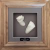 103- White hand & foot casts in oak wood frame with grey backing